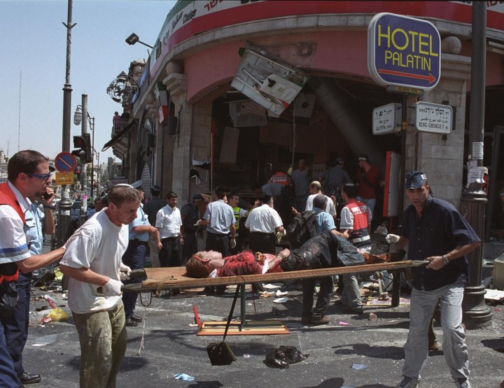 An injured girl is evacuated from the scene of a Palestinian suicide bombing at the Sbarro restaurant in Jerusalem August 9, 2001.Photo by Flash90